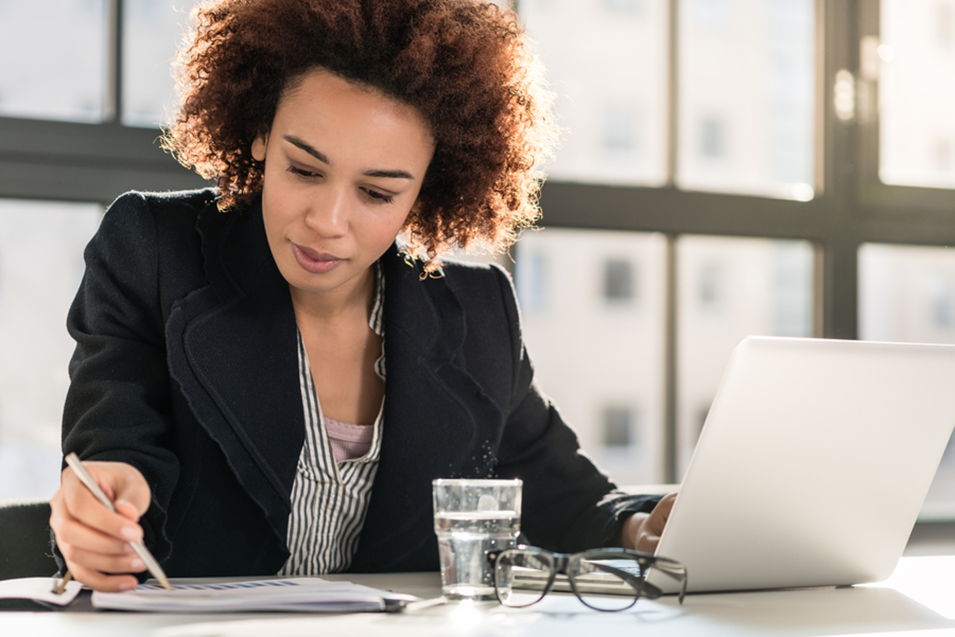 Woman looking at information in a notebook.